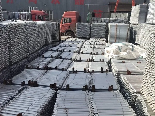 Trucks loading galvanized scaffolding in the yard